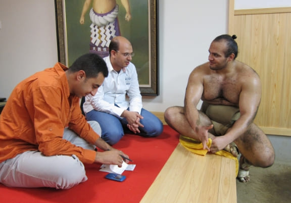 Newspaper journalists from Egypt interviewing sumo wrestler Osunaarashi while in Japan (September 2013)