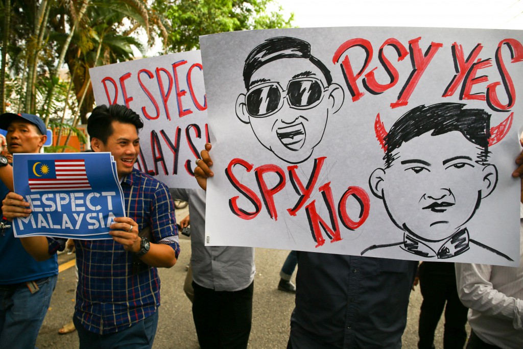 Members of the Youth Wing of the National Front hold placards during a protest at the North Korea embassy in Kuala Lumpur